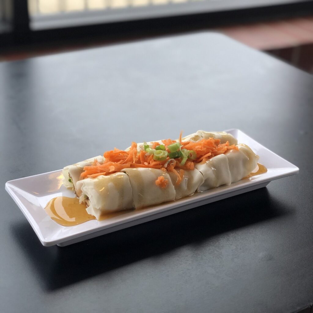 Best Thai Spring Rolls in Chicago. Garnisheed with carrots and green onions, served with a tart sauce.