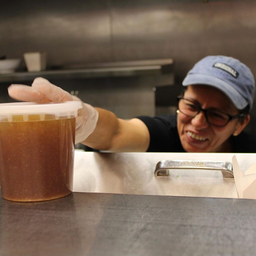 Maria from Thai Pot Noodles Shop finishing an order of Miso soup