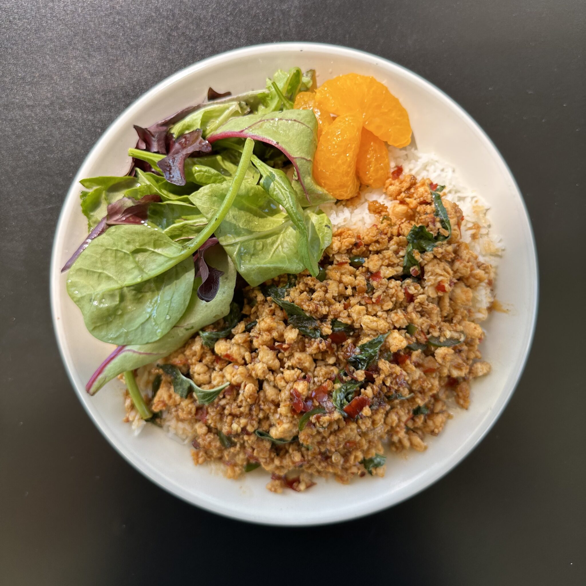 Gai Kra Praow served with a side of spring salad