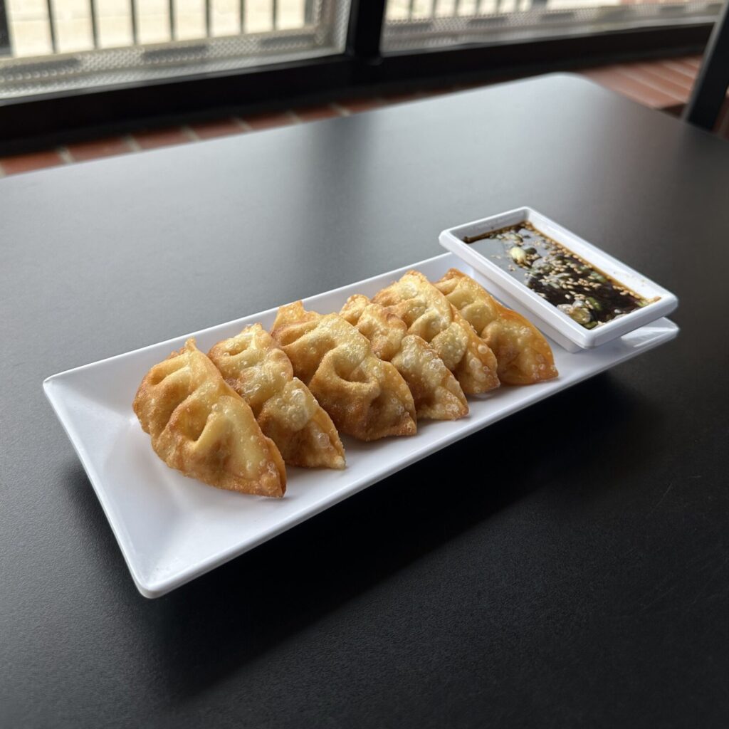 Pot Stickers (Gyoza) dumplings filled with pork and vegetables. Served with a house soy sauce at Thai Pot Noodles Shop in Chicago.